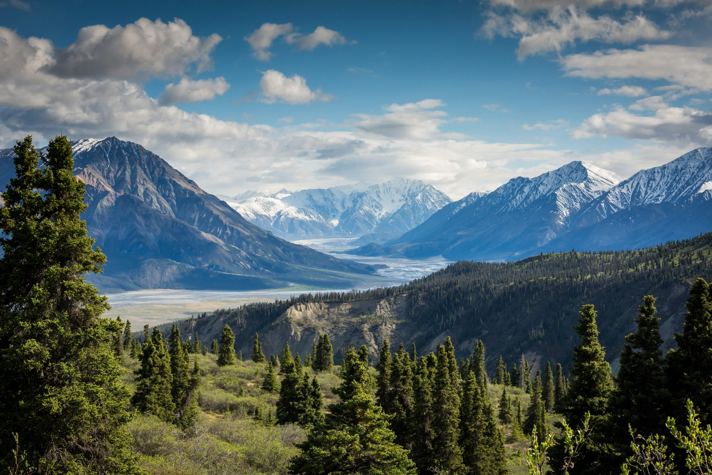 Snow-covered ridgeline above a high mountain valley